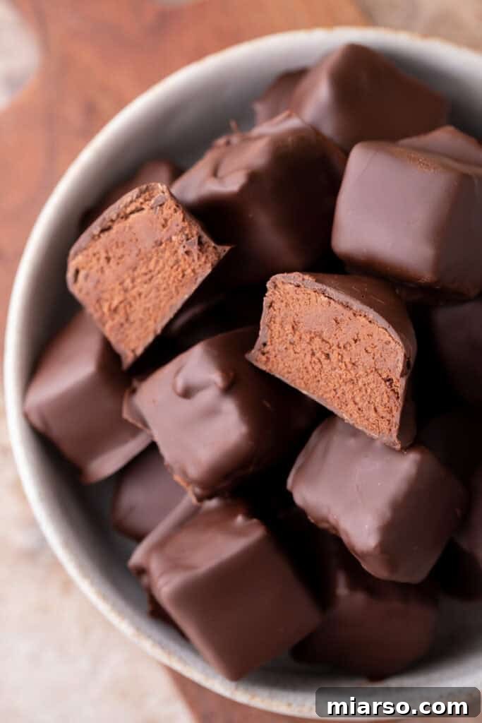 Effortless Three Musketeers Cool Whip Treats 12 Bowl of homemade cool whip candy with smooth chocolate coating and soft centers.