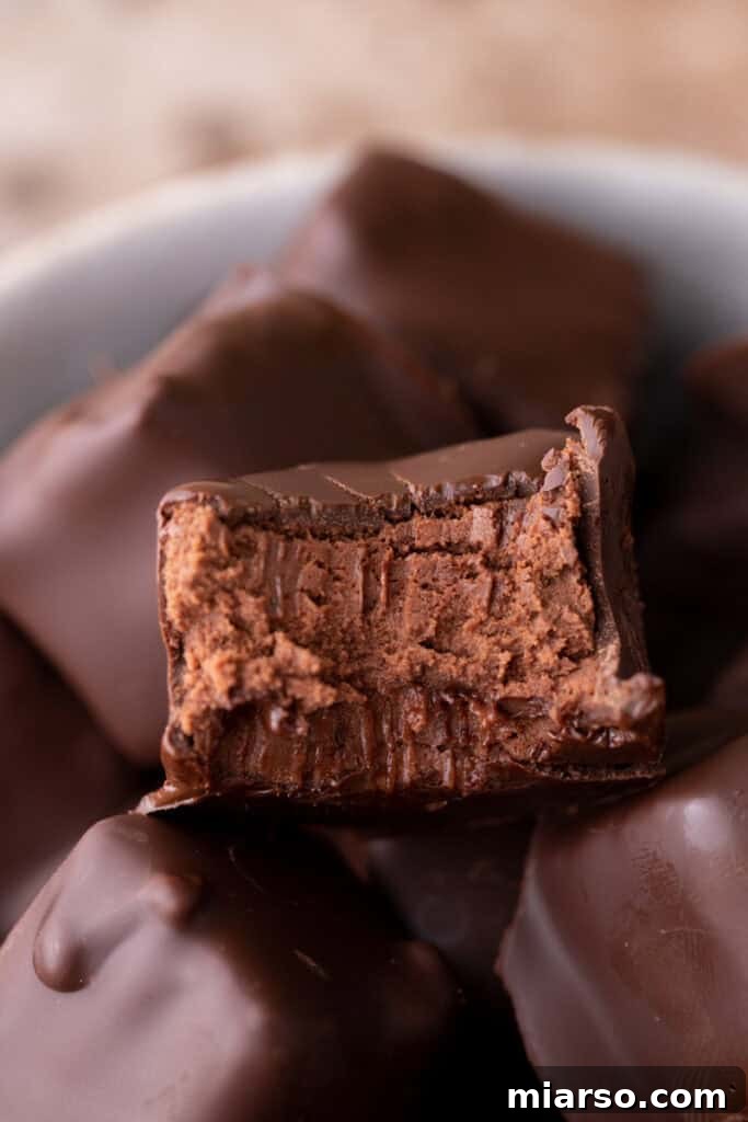 Effortless Three Musketeers Cool Whip Treats 13 A partially eaten chocolate candy revealing its soft chocolate mousse interior.