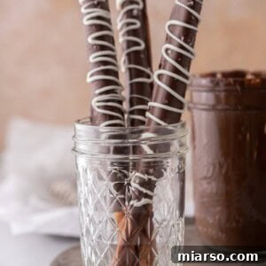 Decadent Caramel Chocolate Pretzel Rods 14 three caramel chocolate covered pretzel rods in a cup