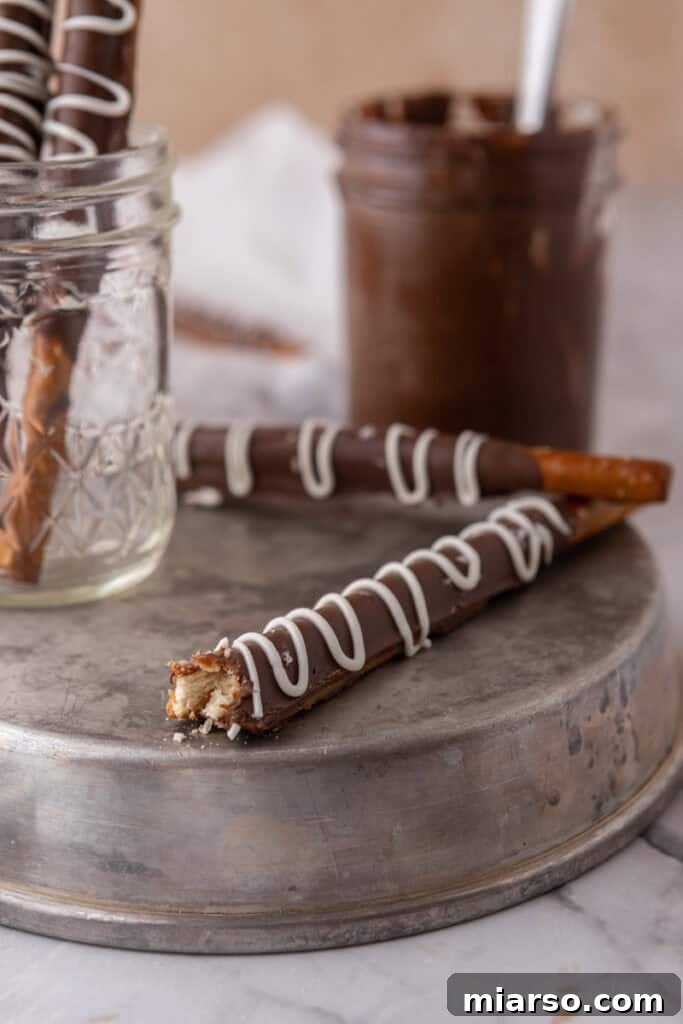 Decadent Caramel Chocolate Pretzel Rods 4 A stunning side shot of several caramel chocolate covered pretzel rods, showcasing their perfectly layered textures and inviting appearance.