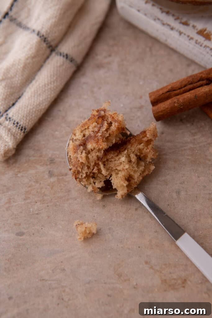 Close-up shot of a spoonful of snickerdoodle mug cake recipe, showing its soft interior