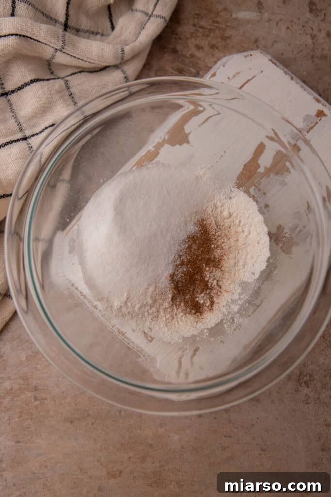 Unmixed dry ingredients in a bowl for snickerdoodle mug cake