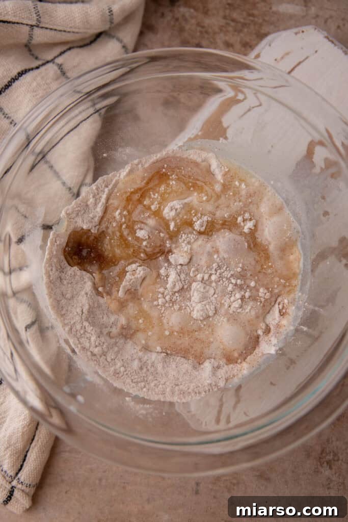 Adding wet ingredients to dry ingredients for snickerdoodle mug cake