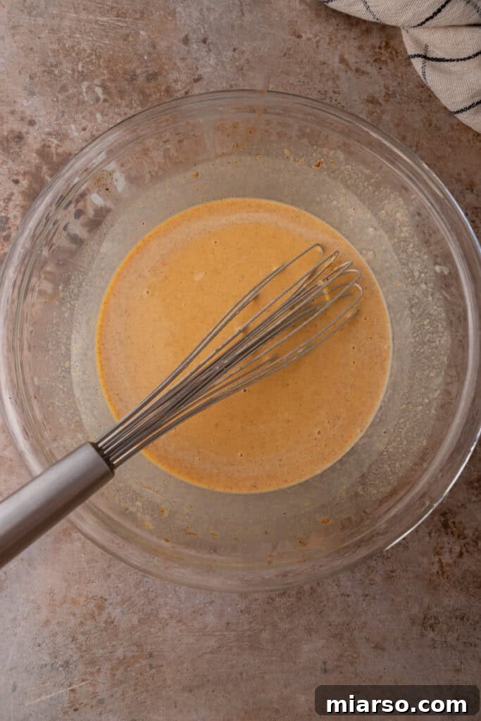 Pumpkin French toast custard ingredients mixed smoothly in a bowl.
