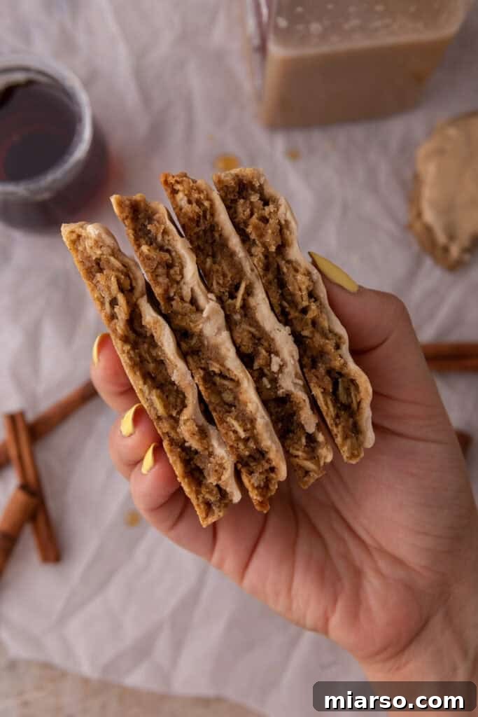 maple glazed oatmeal cookies being held up by a hand