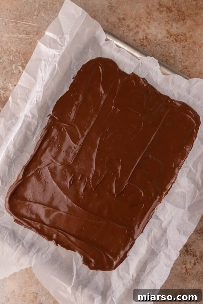The Ultimate Caramel Apple Bark Recipe 5 chocolate on a baking pan