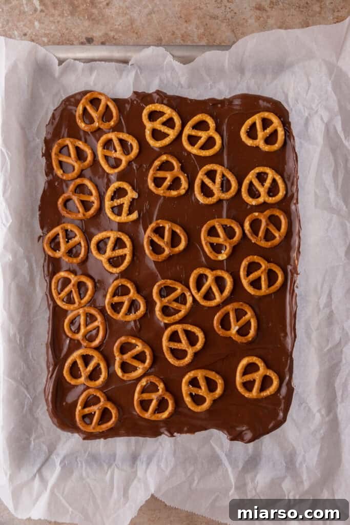 The Ultimate Caramel Apple Bark Recipe 6 pretzels on top of the chocolate