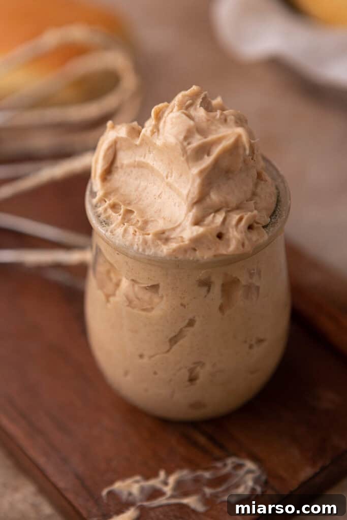 texas roadhouse cinnamon butter in a cup with a scoop taken out