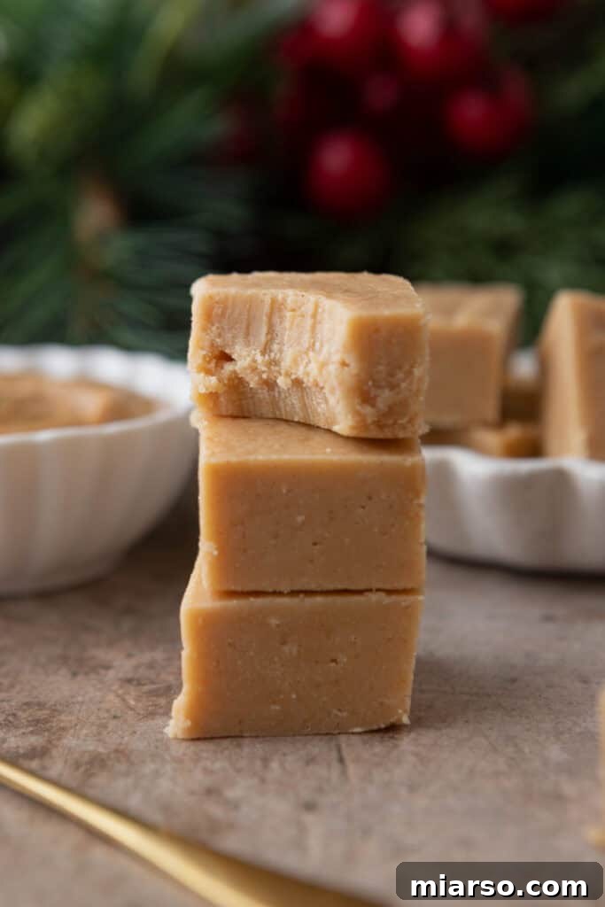 Effortless Microwave Peanut Butter Fudge 4 Stacked squares of finished microwave peanut butter fudge, ready to be enjoyed.