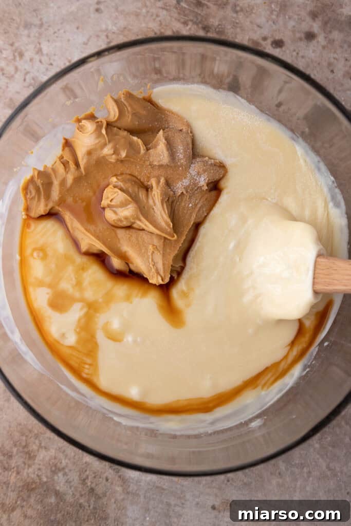 Effortless Microwave Peanut Butter Fudge 6 Close-up of white chocolate chips and sweetened condensed milk in a microwave-safe bowl, ready for melting.