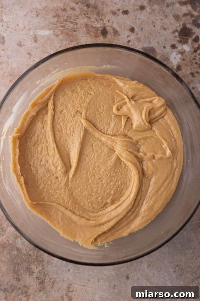 Effortless Microwave Peanut Butter Fudge 7 The fully mixed peanut butter fudge batter in a bowl, showcasing its smooth texture.
