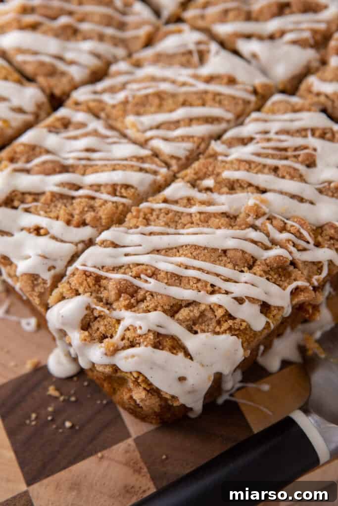 The fully baked pumpkin coffee cake recipe, glistening with a fresh vanilla glaze and ready to be served.