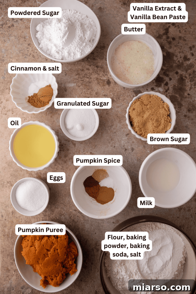 A vibrant display of fresh ingredients for pumpkin coffee cake, including flour, sugar, spices, eggs, pumpkin puree, and butter, neatly arranged for baking.