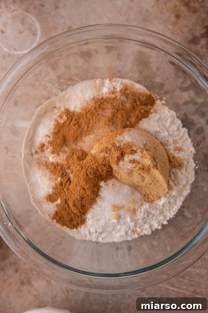 Separate bowls of dry and wet ingredients for the pumpkin coffee cake, ready to be combined.