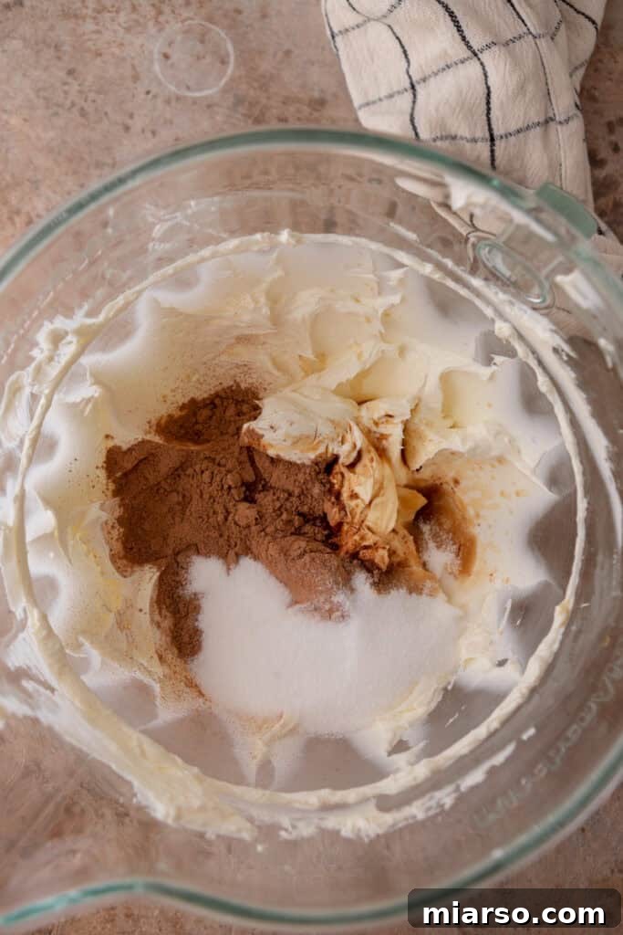 A bowl with semi-sweet chocolate chips and heavy cream, ready to be turned into a ganache.