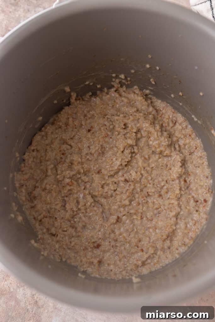 Cooked steel cut oats in the Instant Pot after pressure release, showing a creamy, thick consistency.