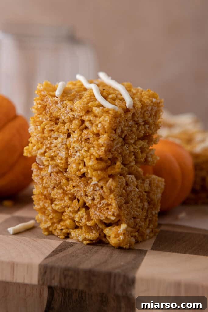 Delicious pumpkin rice krispie treats arranged on a platter, ready to be served.