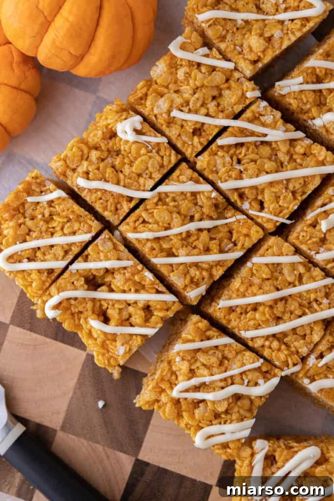 Overhead shot of freshly made pumpkin rice krispie treats, still warm and inviting.
