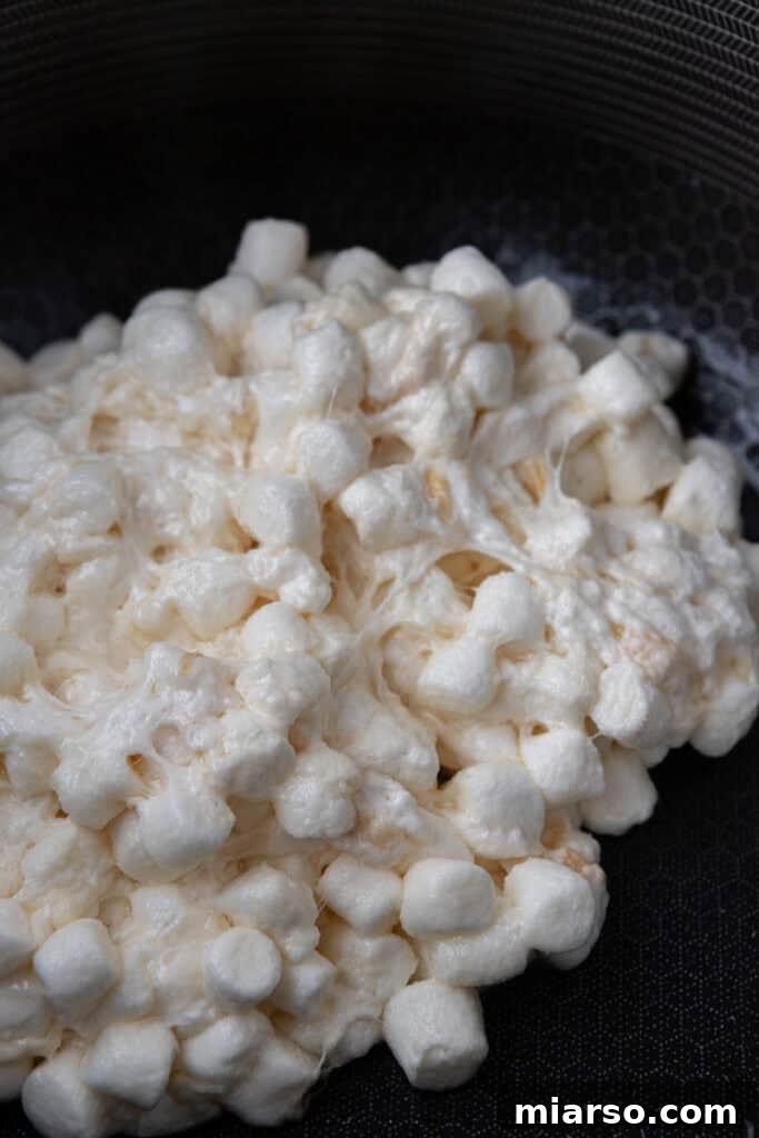 Close-up of mini marshmallows melting in a pot with butter.