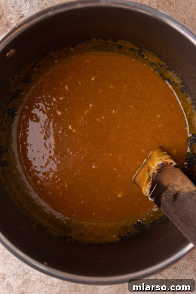 Pumpkin puree, pumpkin pie spice, cinnamon, and vanilla extract mixed into the melted marshmallow base.