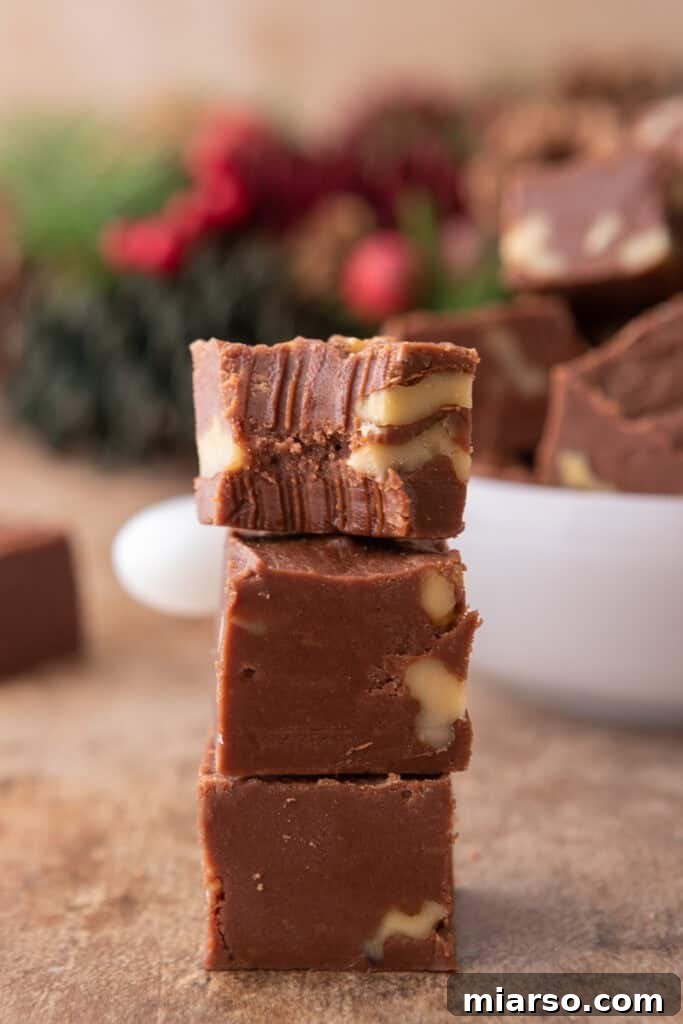see's candy fudge recipe pieces stacked on top of each other, showcasing their perfect square shape and delicious appearance