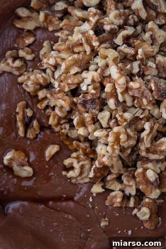 chocolate chips and marshmallow cream melting into the hot mixture, demonstrating the next step in fudge making