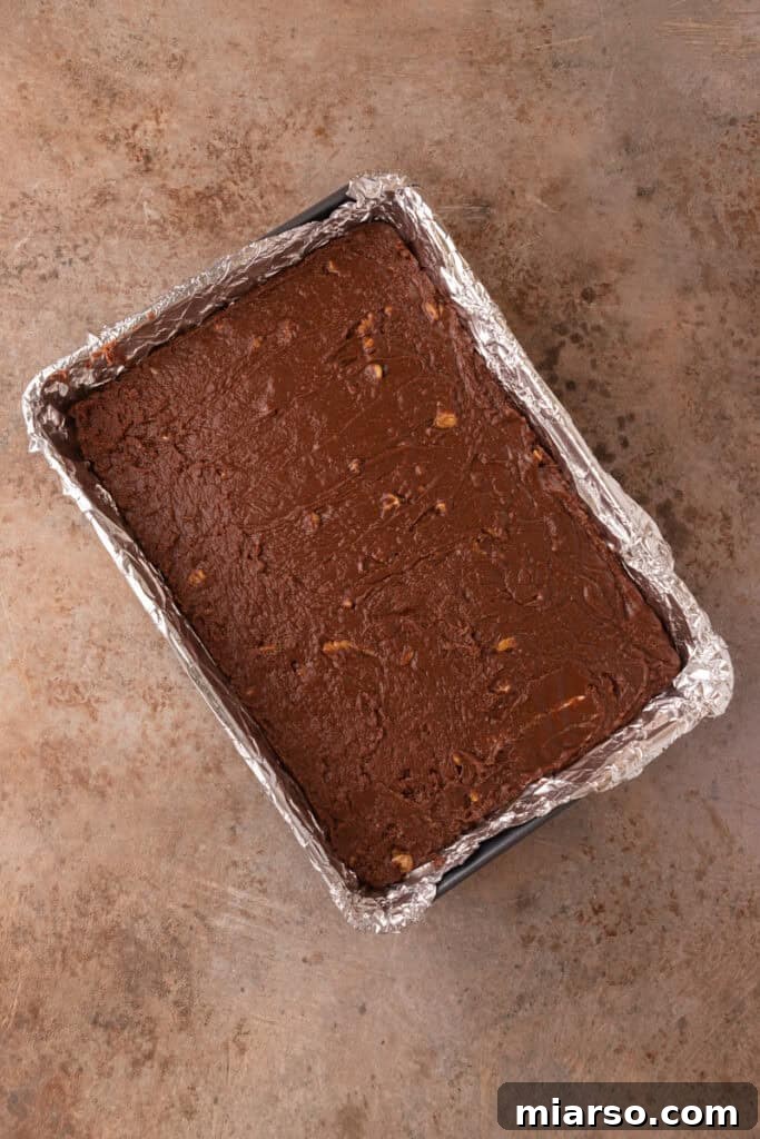 finished fudge product resting in a pan, cooling down before being cut into squares