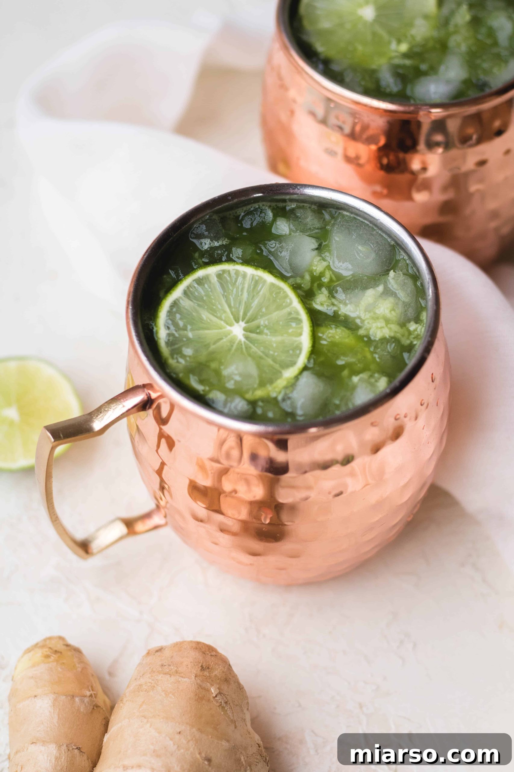 A perfectly garnished Matcha Moscow Mule in a copper mug