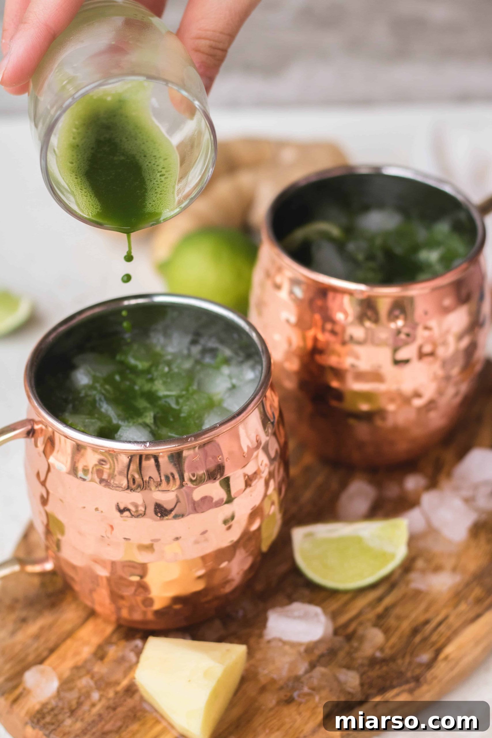 Another view of pouring matcha into a copper mug