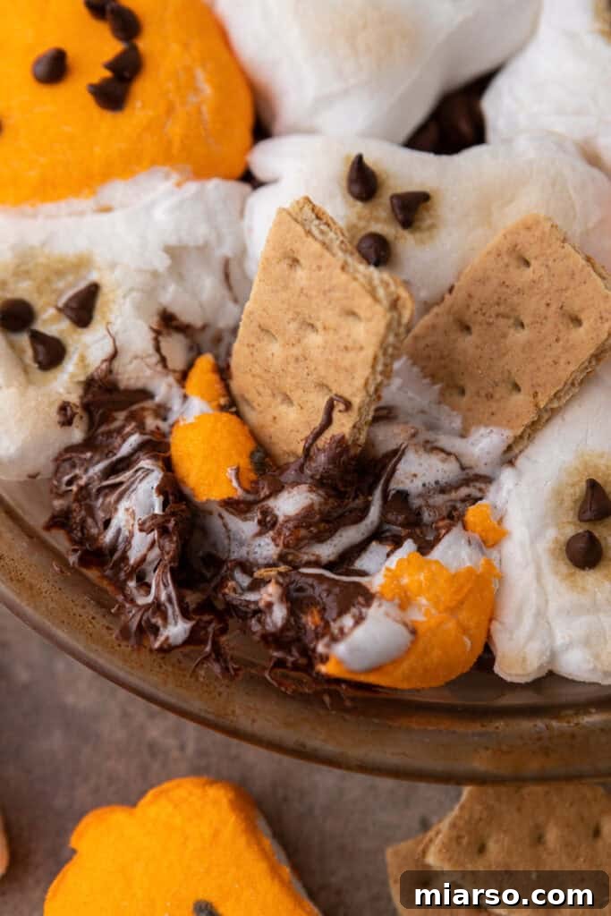 Bewitching Halloween S'mores Dip 8 Halloween S'mores Dip Recipe getting scooped up