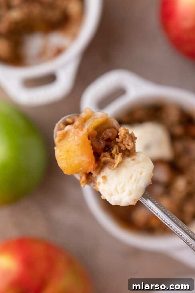 A spoonful of homemade Microwave Apple Crisp for One, showcasing the tender apples and crunchy topping.