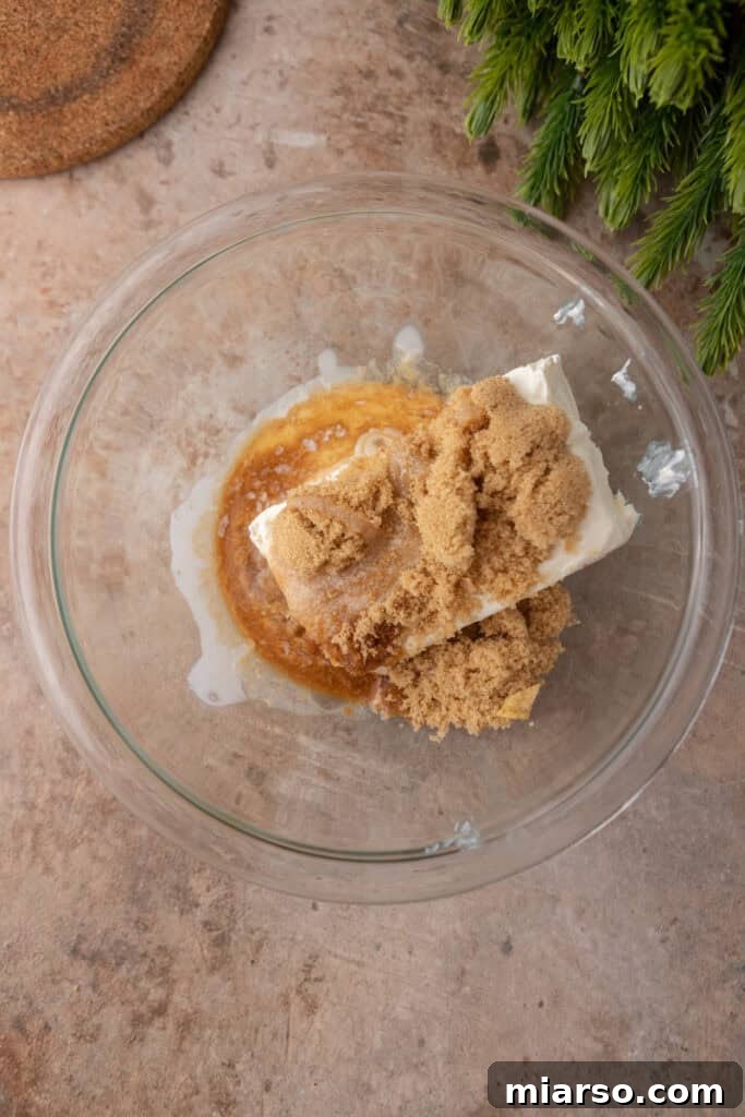 Irresistible Pecan Pie Dip 7 Unmixed cream cheese layer ingredients in a mixing bowl.