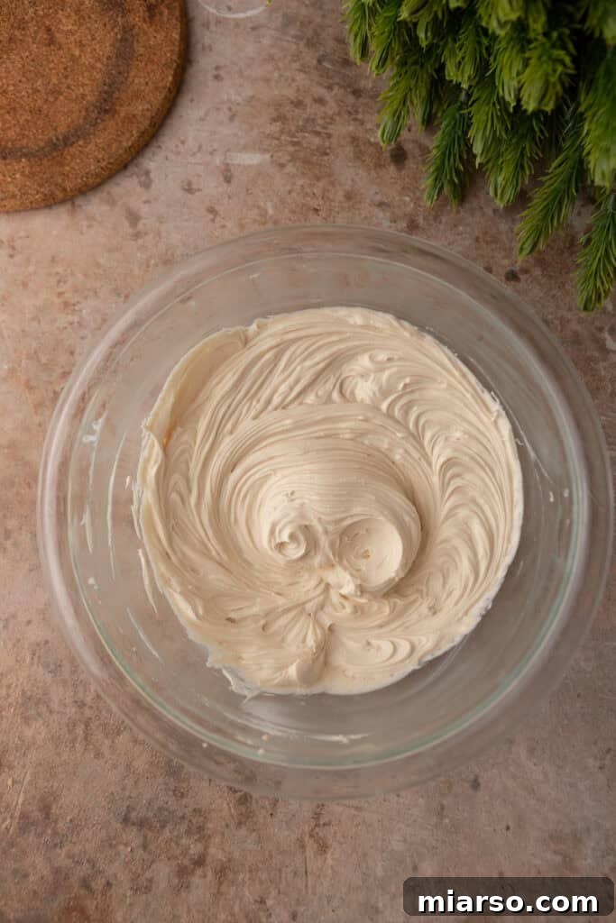 Irresistible Pecan Pie Dip 8 Mixed and fluffy cream cheese layer ingredients in a mixing bowl.