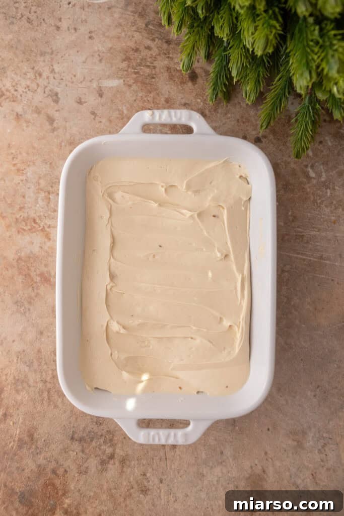 Irresistible Pecan Pie Dip 9 Smooth cream cheese layer spread evenly at the bottom of a serving dish.