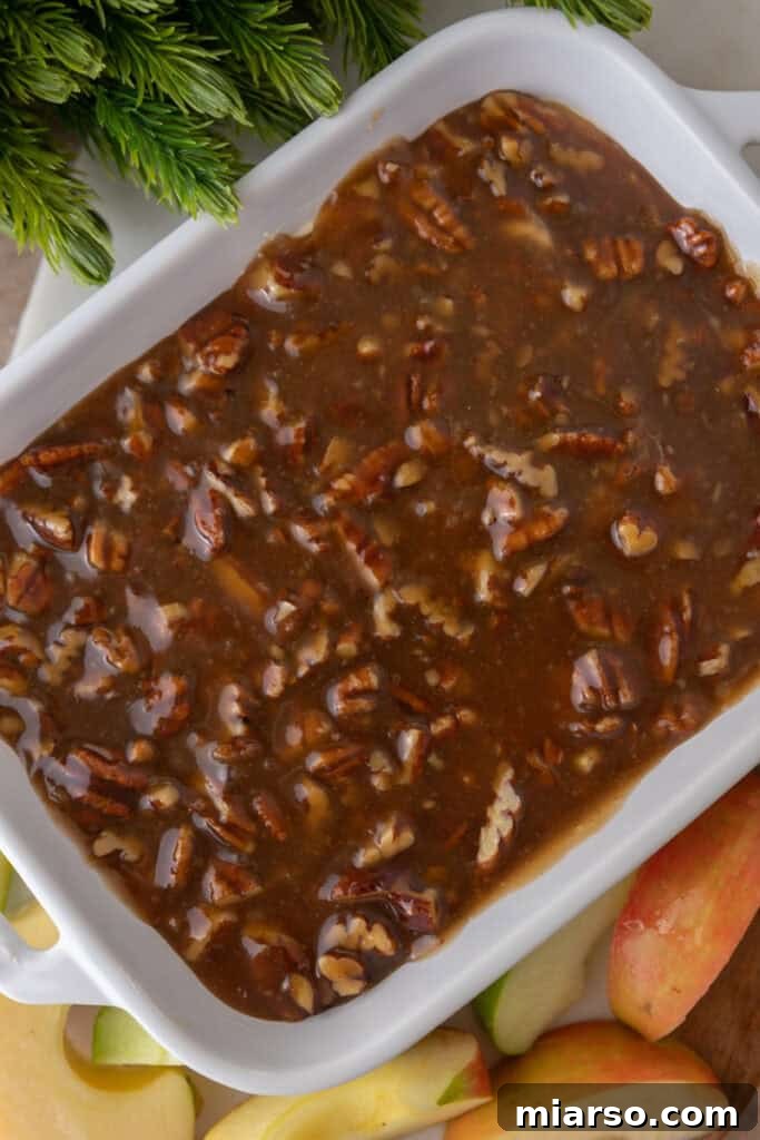 Irresistible Pecan Pie Dip 10 Pecan pie topping carefully spread over the cream cheese layer in a serving dish, creating the complete dip.