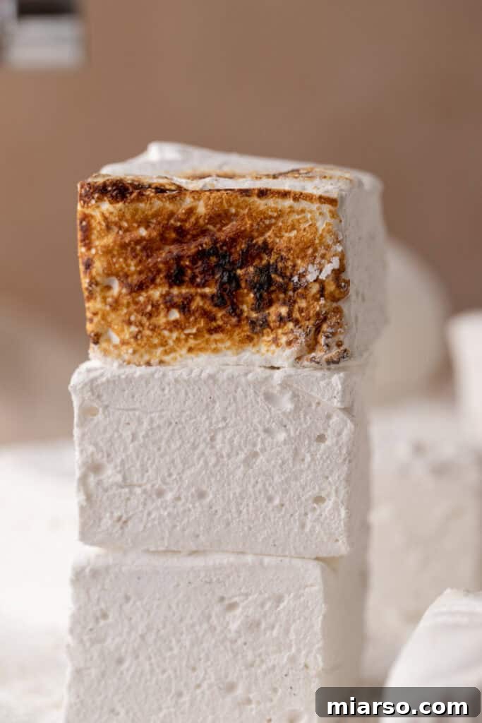 homemade marshmallows stacked on top of each other, showcasing their fluffy texture