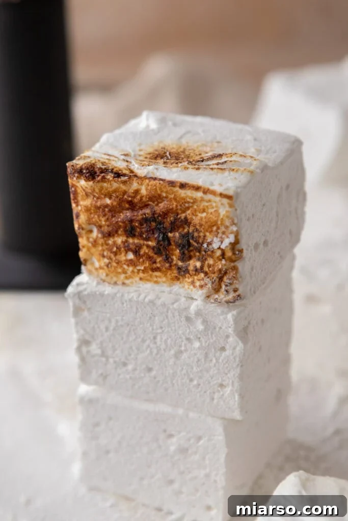homemade marshmallows stacked on top of each other, ready to be enjoyed