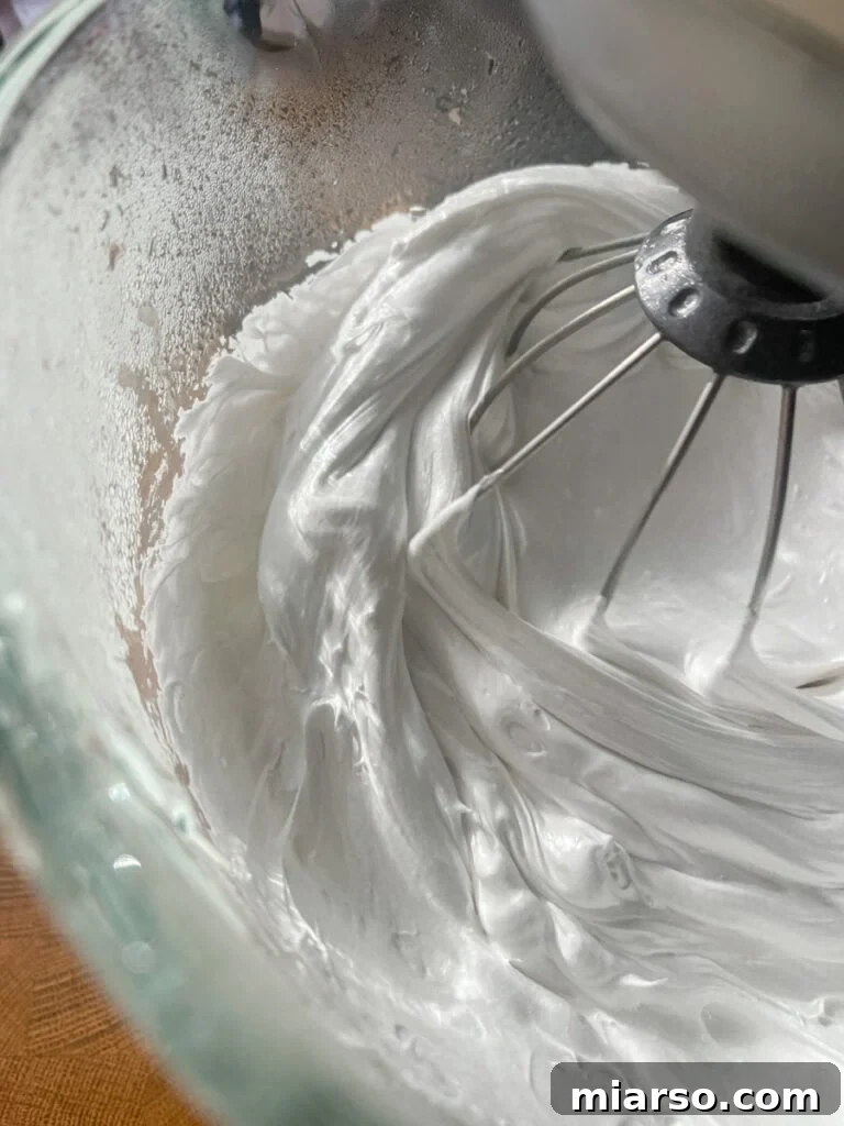 fluffy marshmallow mixture in a stand mixer, fully whipped