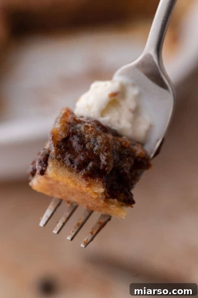 a piece of the chocolate chip cookie pie recipe on a fork, showing its gooey texture