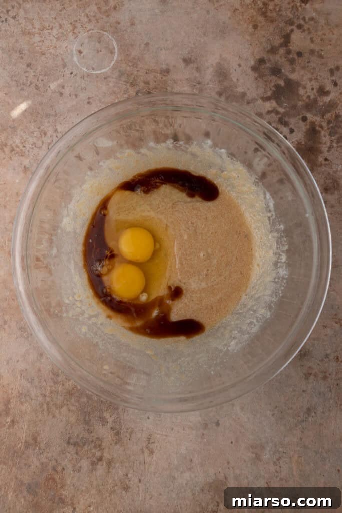 unmixed ingredients for cookie pie in a bowl, before whisking