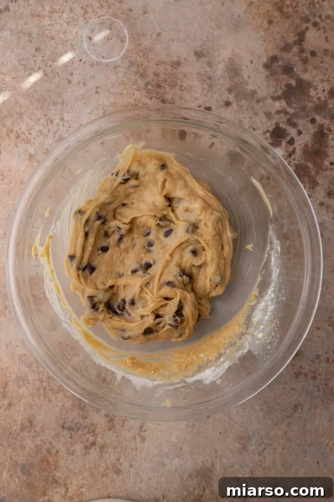 mixed ingredients for cookie pie in a bowl, forming the dough