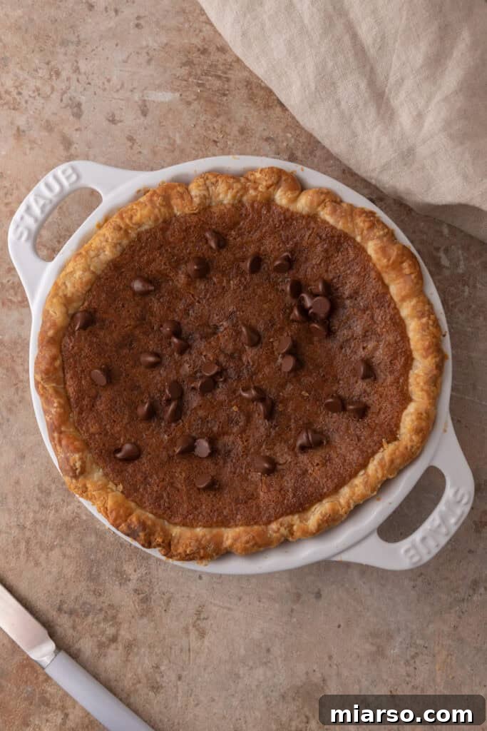 fully baked chocolate chip cookie pie, golden brown and ready to cool