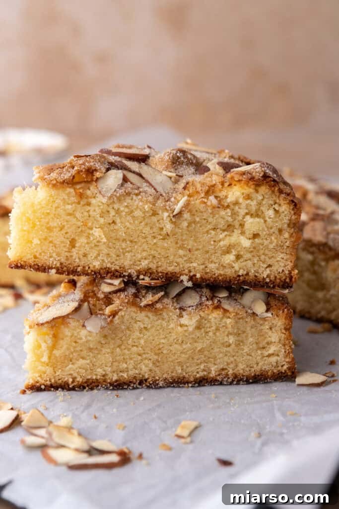 Two perfect slices of moist homemade almond cake stacked beautifully