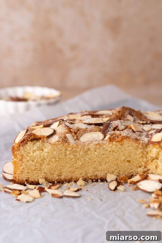 A side view of the almond cake, showing its moist and tender crumb structure