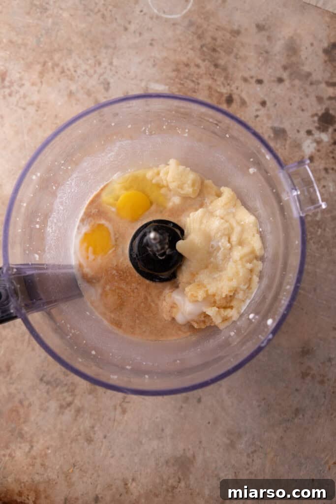 Butter added to the food processor with almond mixture