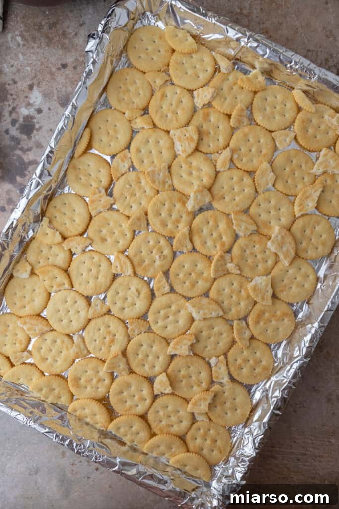 Sweet & Salty Holiday Ritz Toffee Bark 5 crackers on a baking sheet