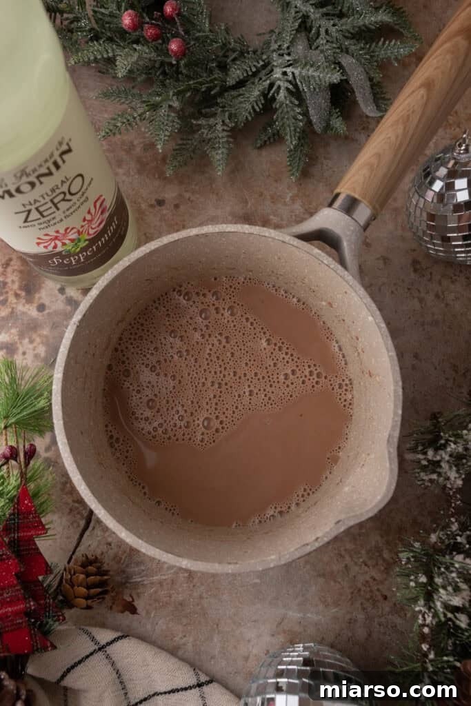 The Ultimate DIY Peppermint Mocha Creamer 6 Whisking Peppermint Mocha Creamer in a pot