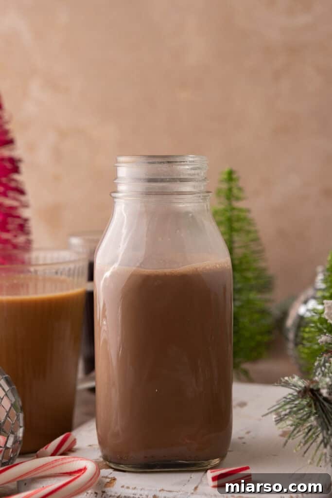 The Ultimate DIY Peppermint Mocha Creamer 8 Peppermint Mocha Creamer in a glass bottle on a festive setup