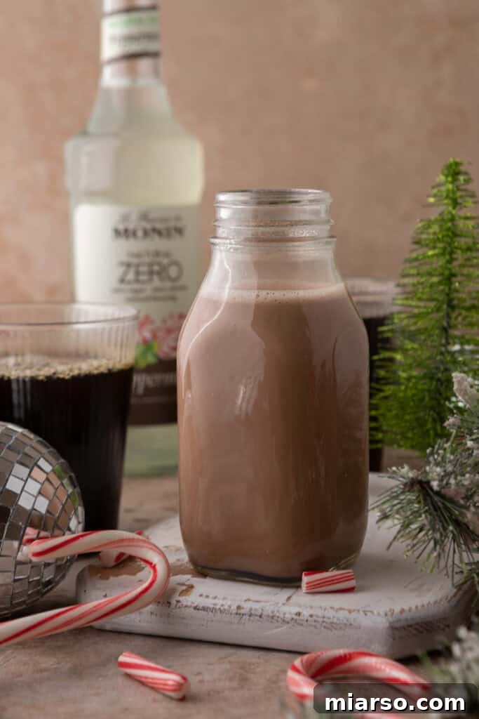 The Ultimate DIY Peppermint Mocha Creamer 9 Peppermint Mocha Creamer in a jar with festive background