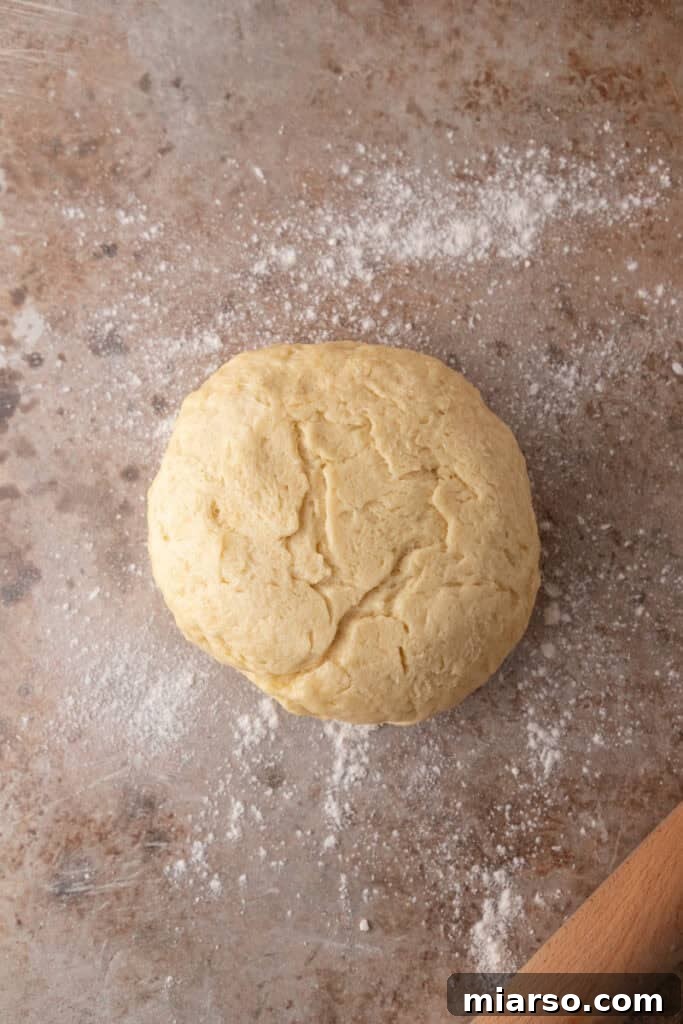 Perfect Small Batch Cinnamon Rolls 7 Small-batch cinnamon roll dough resting on a lightly floured countertop before rolling.